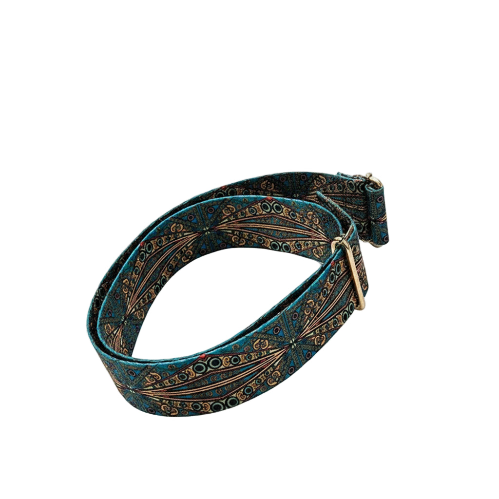 Decorative belt with intricate patterns on a white fabric background